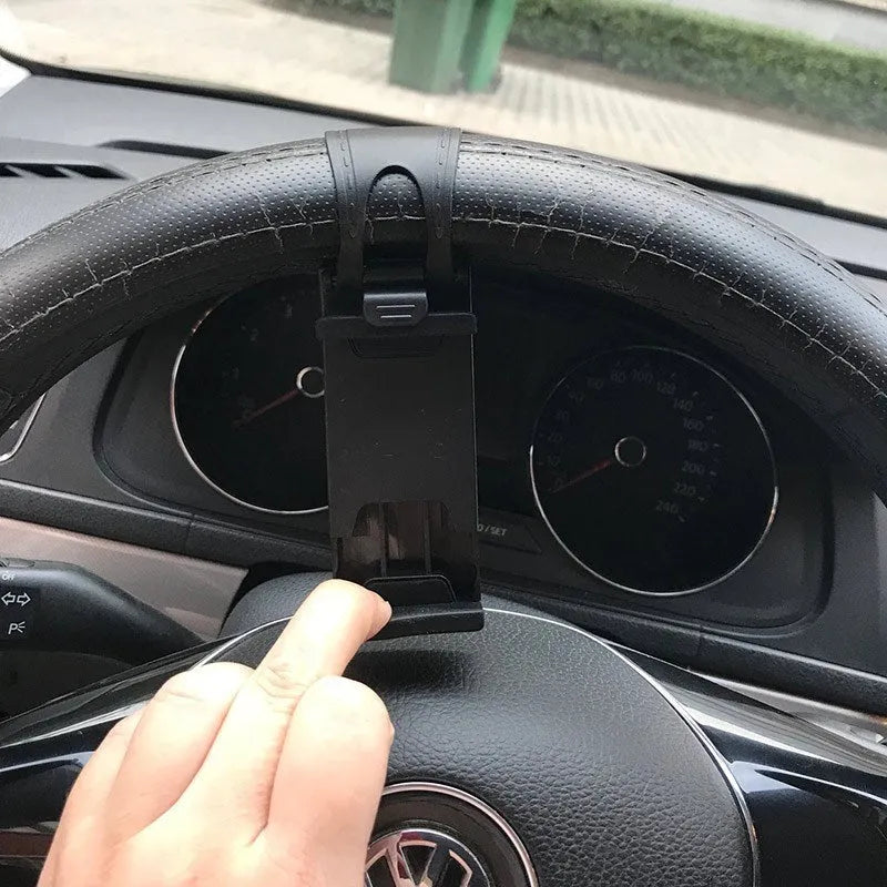 Black steering wheel phone clip holder mounted with smartphone showing navigation display