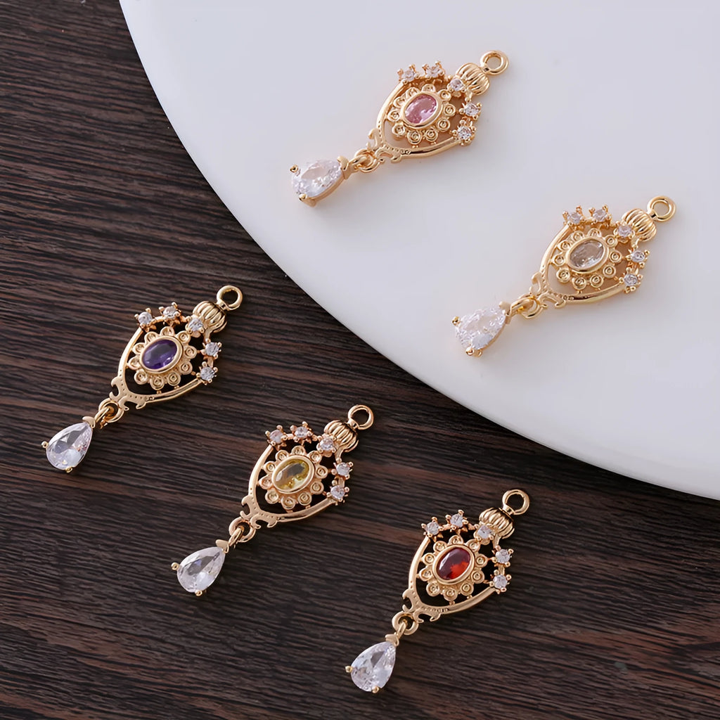 Small gold electroplated copper pendant with hollow crown water drop design and micro-inlaid zircon stones.