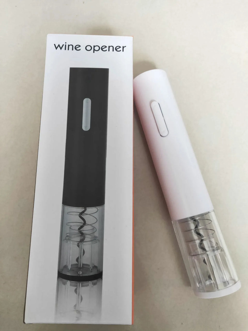Black automatic electric wine opener with foil cutter and transparent window on white background