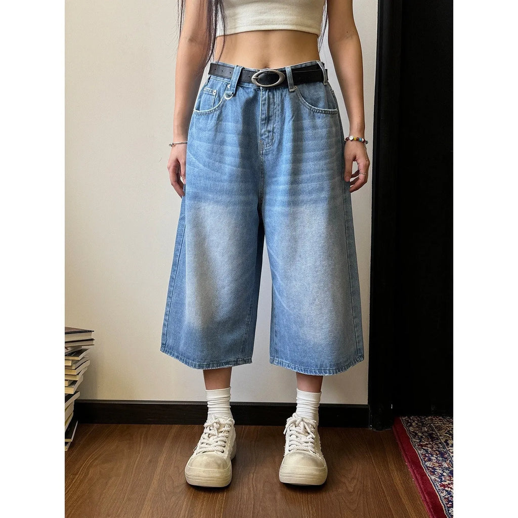 Men's blue loose straight denim shorts for summer on a plain background.