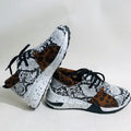 Women's suede flat sneakers with a wedge heel in leopard print, shown from the side.