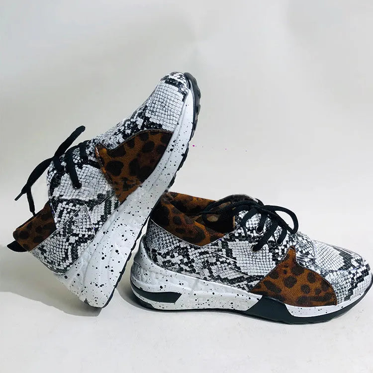 Women's suede flat sneakers with a wedge heel in leopard print, shown from the side.