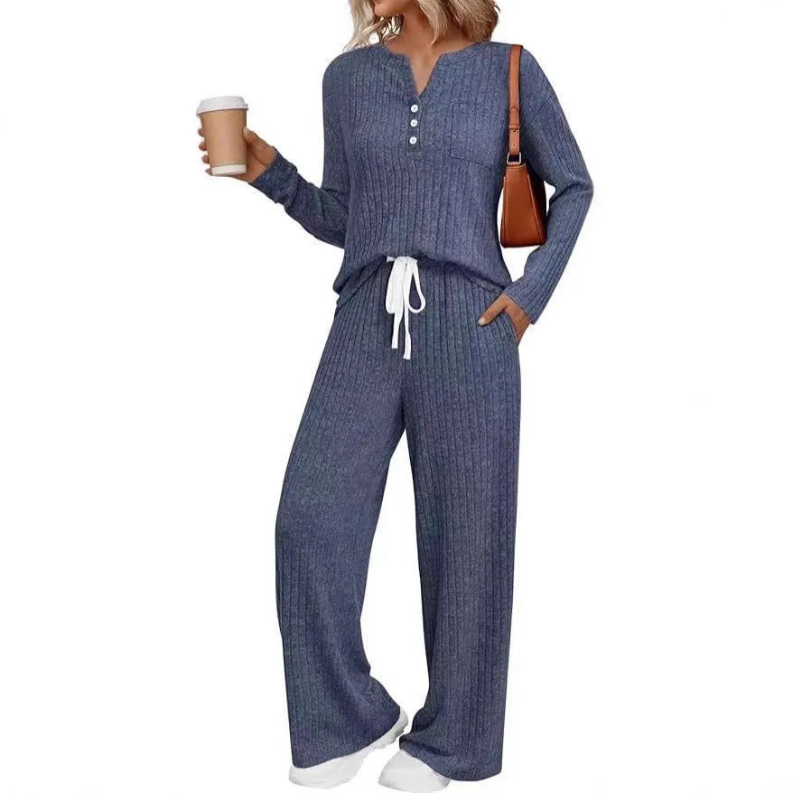 Knitted V-neck striped long coat with long sleeves, pockets, and a lace-up detail on a hanger.