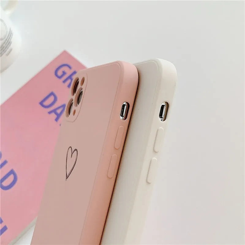 Solid colour silicone TPU back cover case for Apple iPhone on a table, showing colour options.