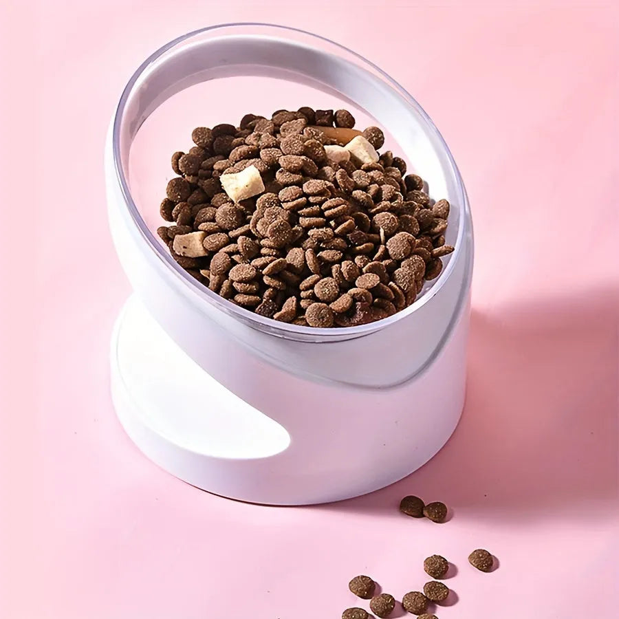 White elevated tilted plastic cat food bowl on a flat surface