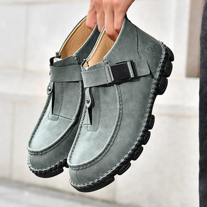 Men's black handmade stitching casual flat bottom slip on shoes made from synthetic leather.
