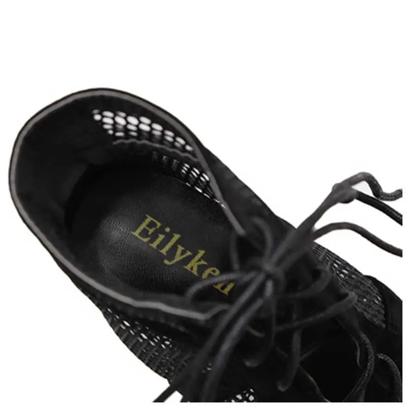 Black suede women's lace-up high heel shoes with a stiletto heel on a white background.