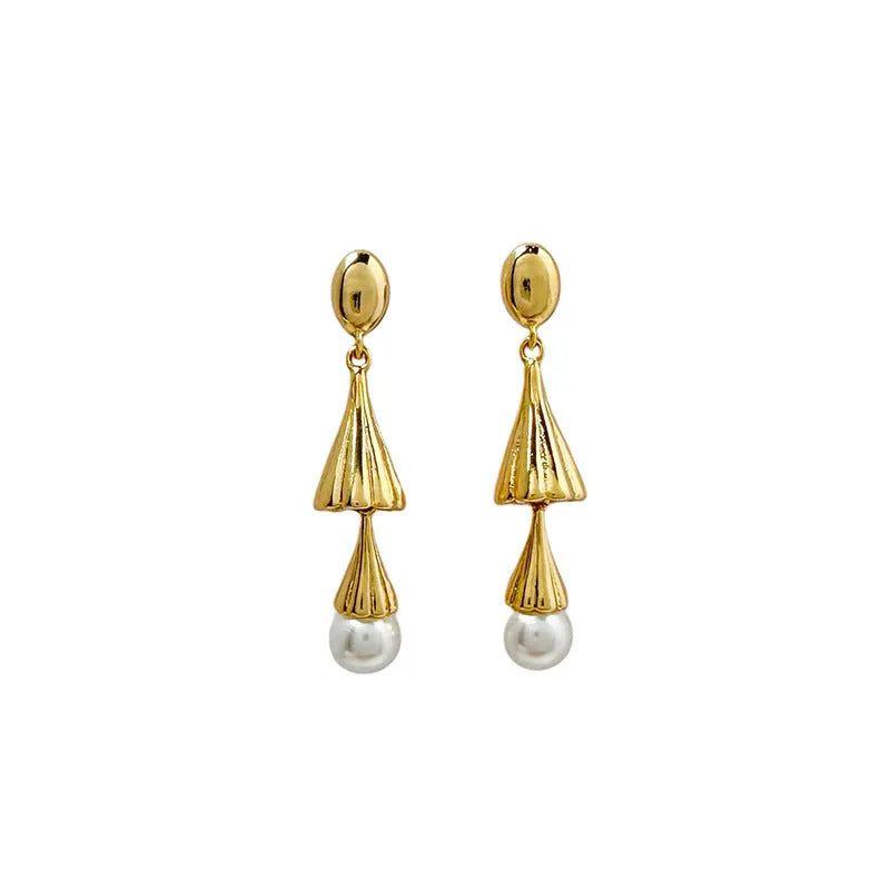 Gold electroplated copper geometric fringe earrings on a woman with long wind chime pearl mosquito coil plate shape close up