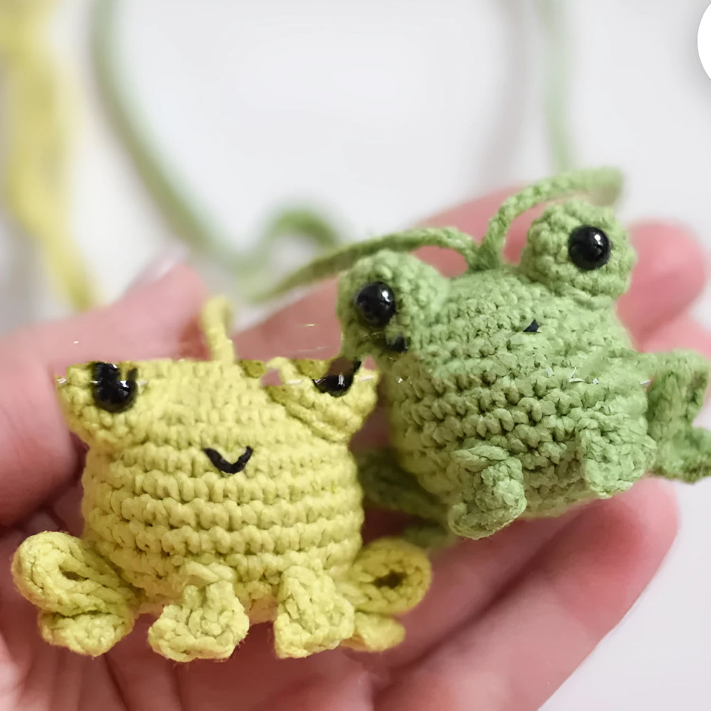 Handmade green plush frog car pendant hanging, showing woven texture and 15cm length