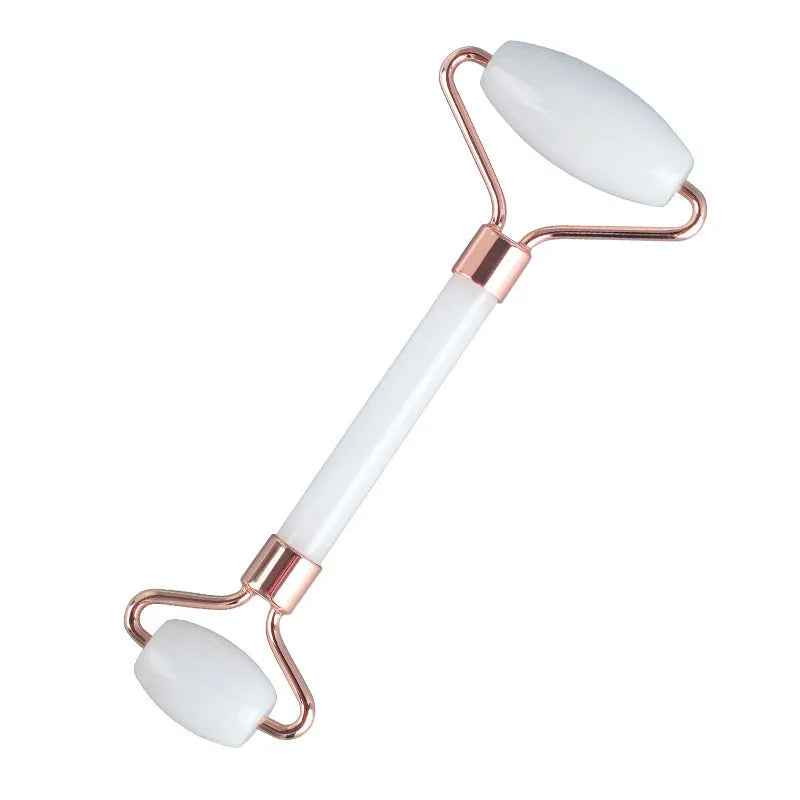 Natural white jade double-headed facial roller and gua sha board set on a plain background.
