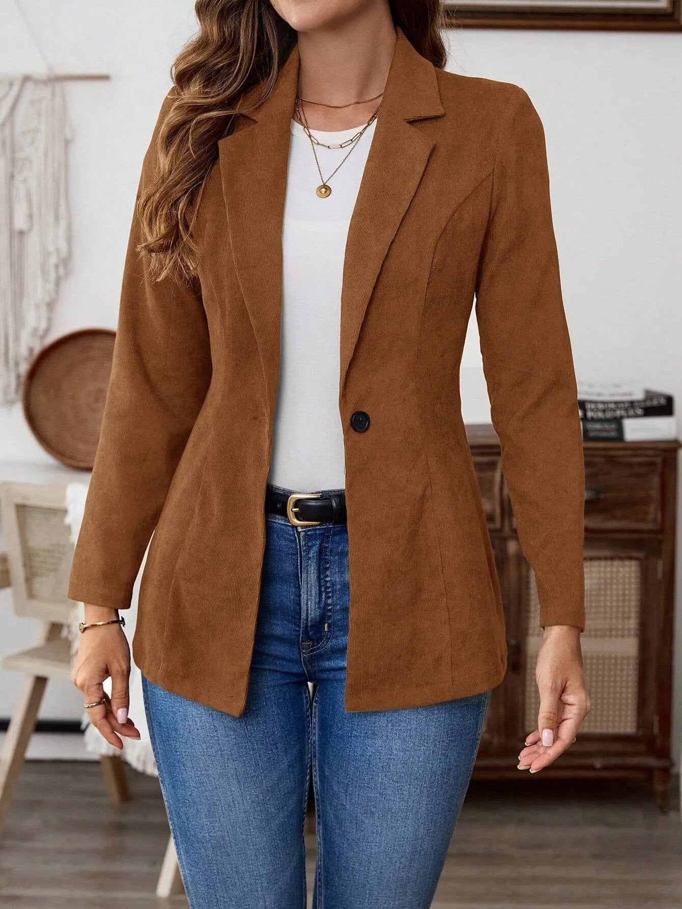 Brown single-breasted leisure suit coat with a lapel collar on a hanger.