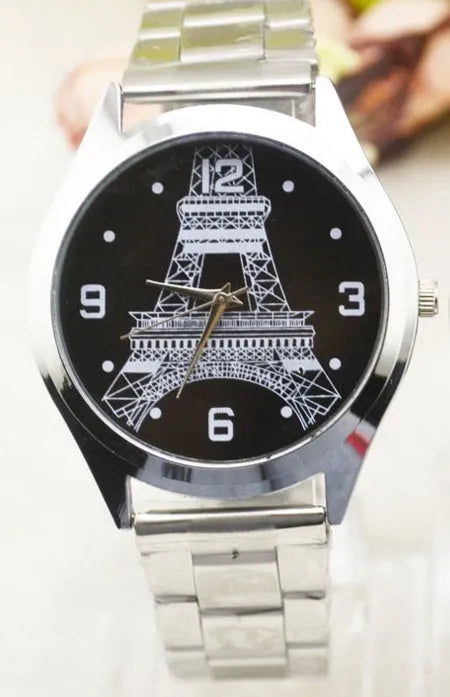 Black leather strap watch with an Eiffel Tower model on the case and an analogue dial