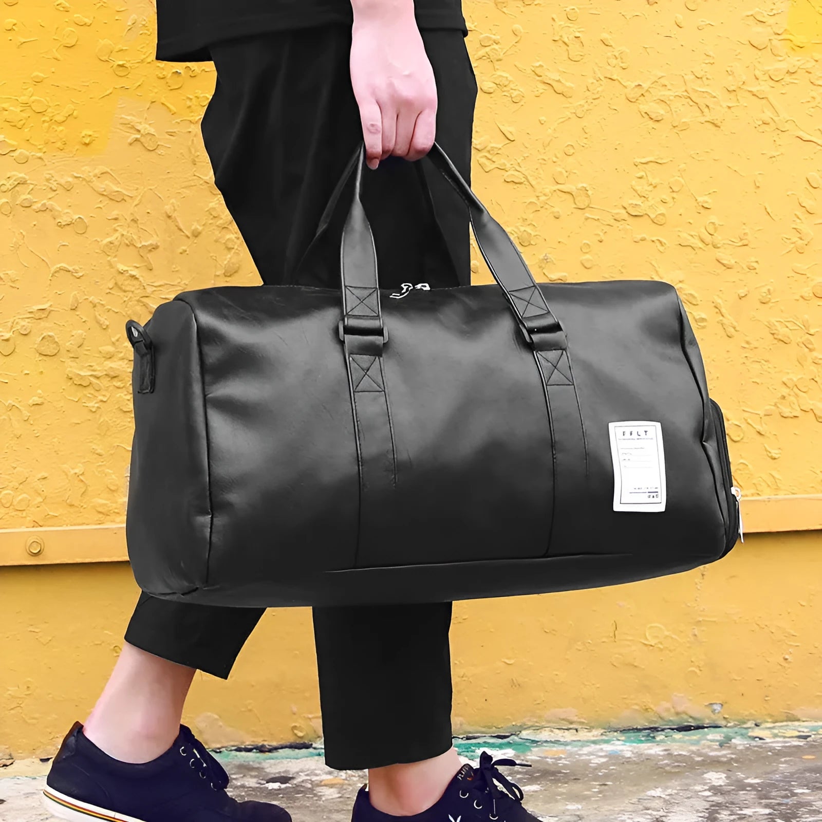 Black waterproof sports bag with separate side compartments for shoes, shown with diagonal carrying strap.
