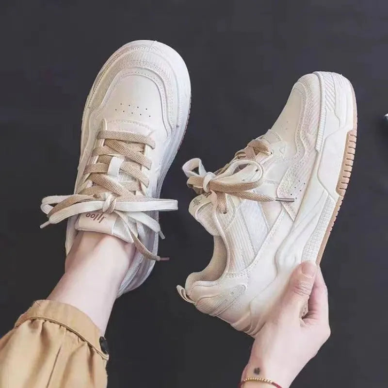 Women's pink low-top sneakers with imitation leather upper and rubber sole for hidden height increase.