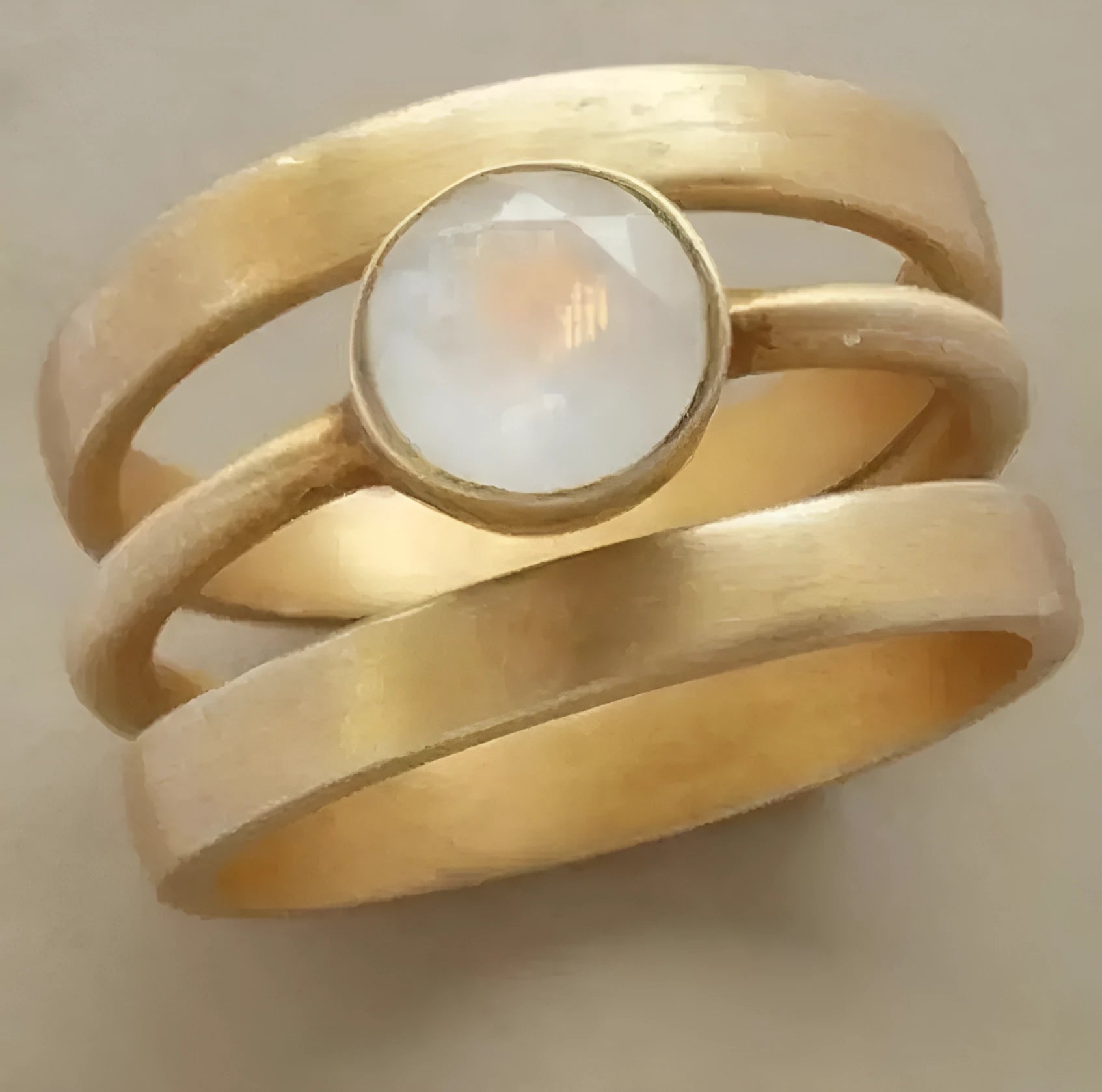 Gold-plated geometric ring with a white chalcedony stone set in a hollow micro-inlaid titanium steel band.