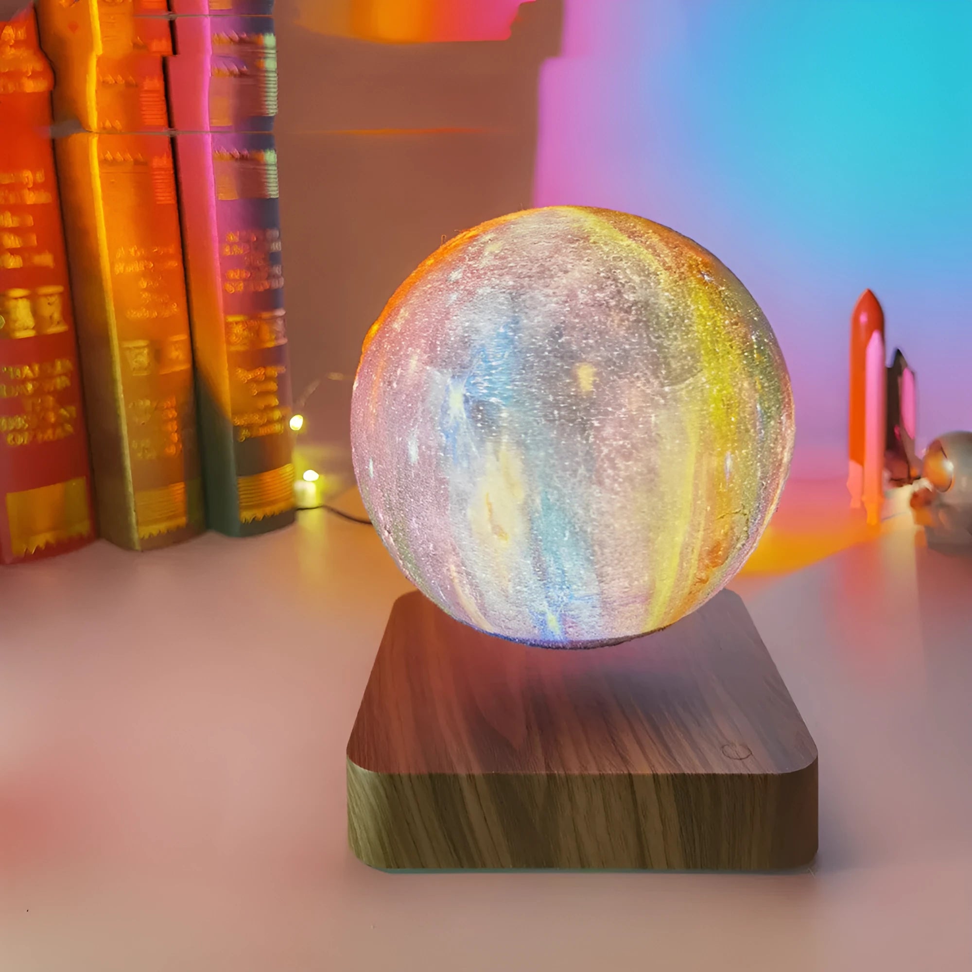 Magnetic levitation galaxy moon lamp floating above walnut-coloured circular base with colourful star details