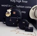 Women's three-piece PU leather backpack set showing backpack, crossbody shoulder bag, and card wallet in matching colour