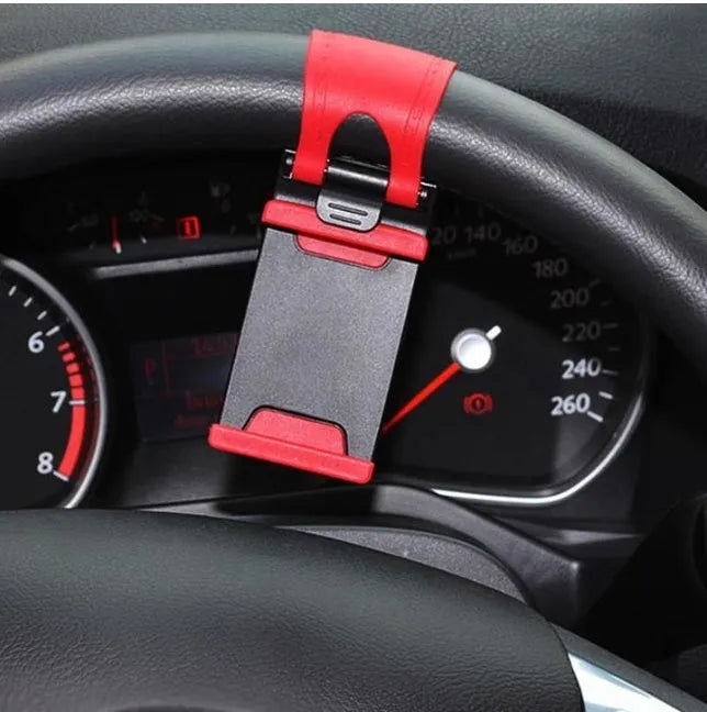 Black steering wheel phone clip holder mounted with smartphone showing navigation display