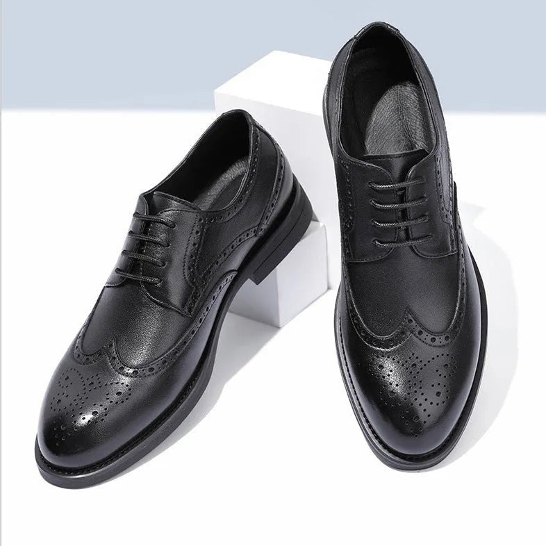 Men's black and brown brogue leather shoes for business style on a plain background.