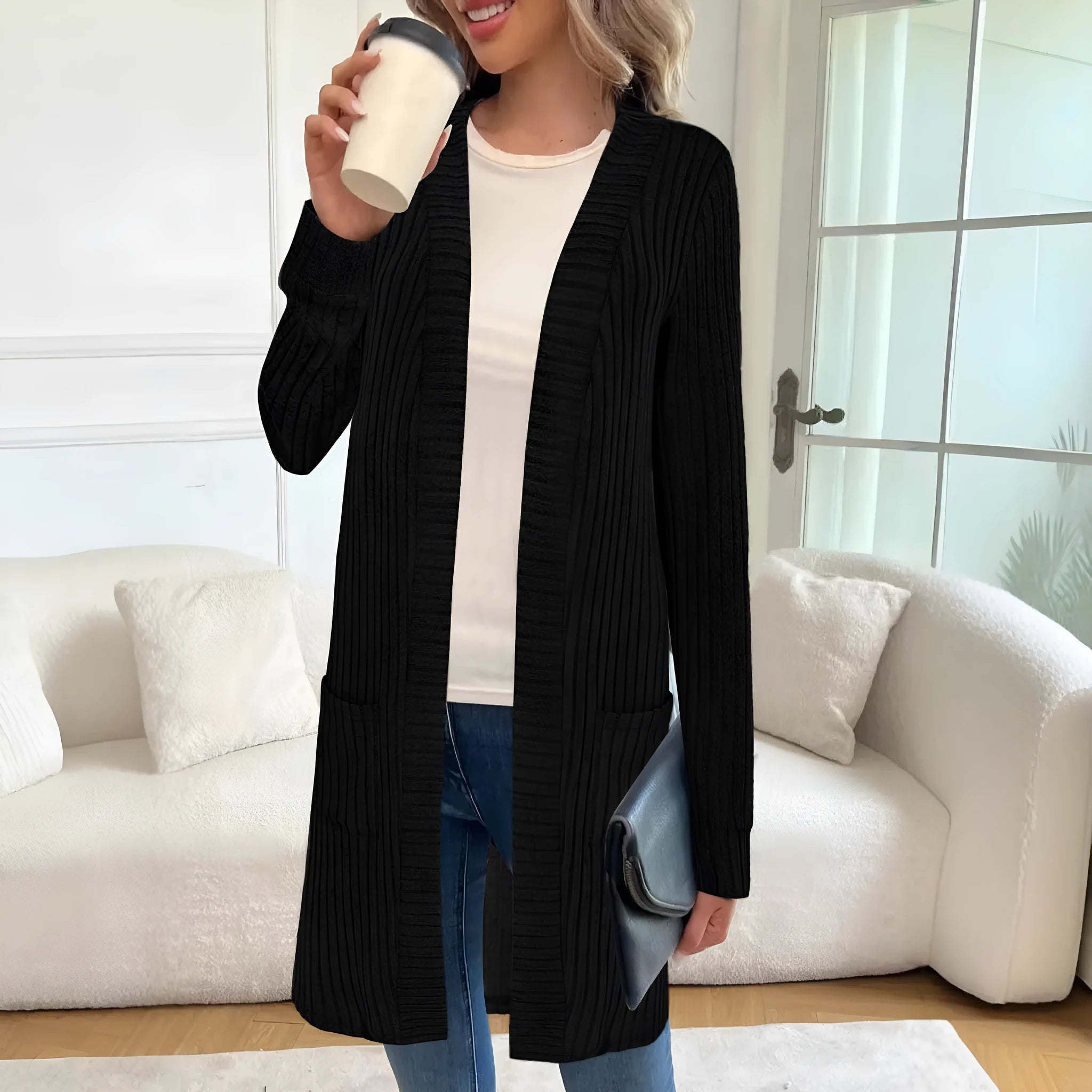 Loose fit grey knitted cardigan jacket with long sleeves and patch pockets on a hanger.