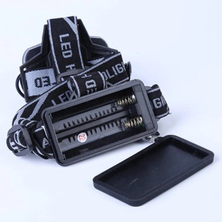 Fixed focus LED head torch with head strap, shown with its included charger.
