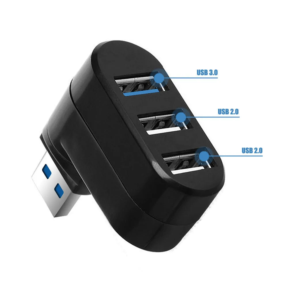 Black or white 4-port USB hub on a desktop next to a laptop and various peripherals.