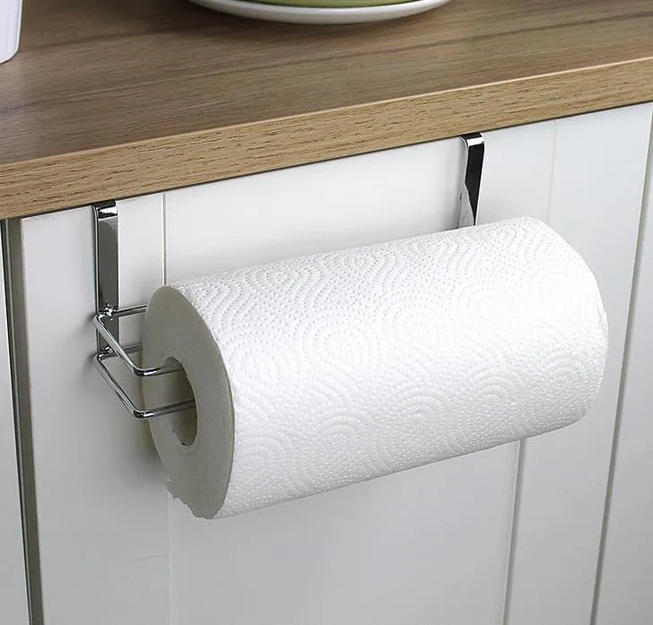 Silver stainless steel paper towel rack mounted on back of white cabinet door.