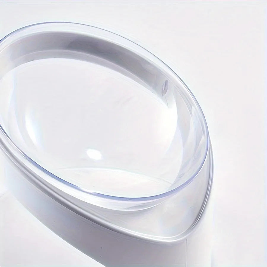 White elevated tilted plastic cat food bowl on a flat surface