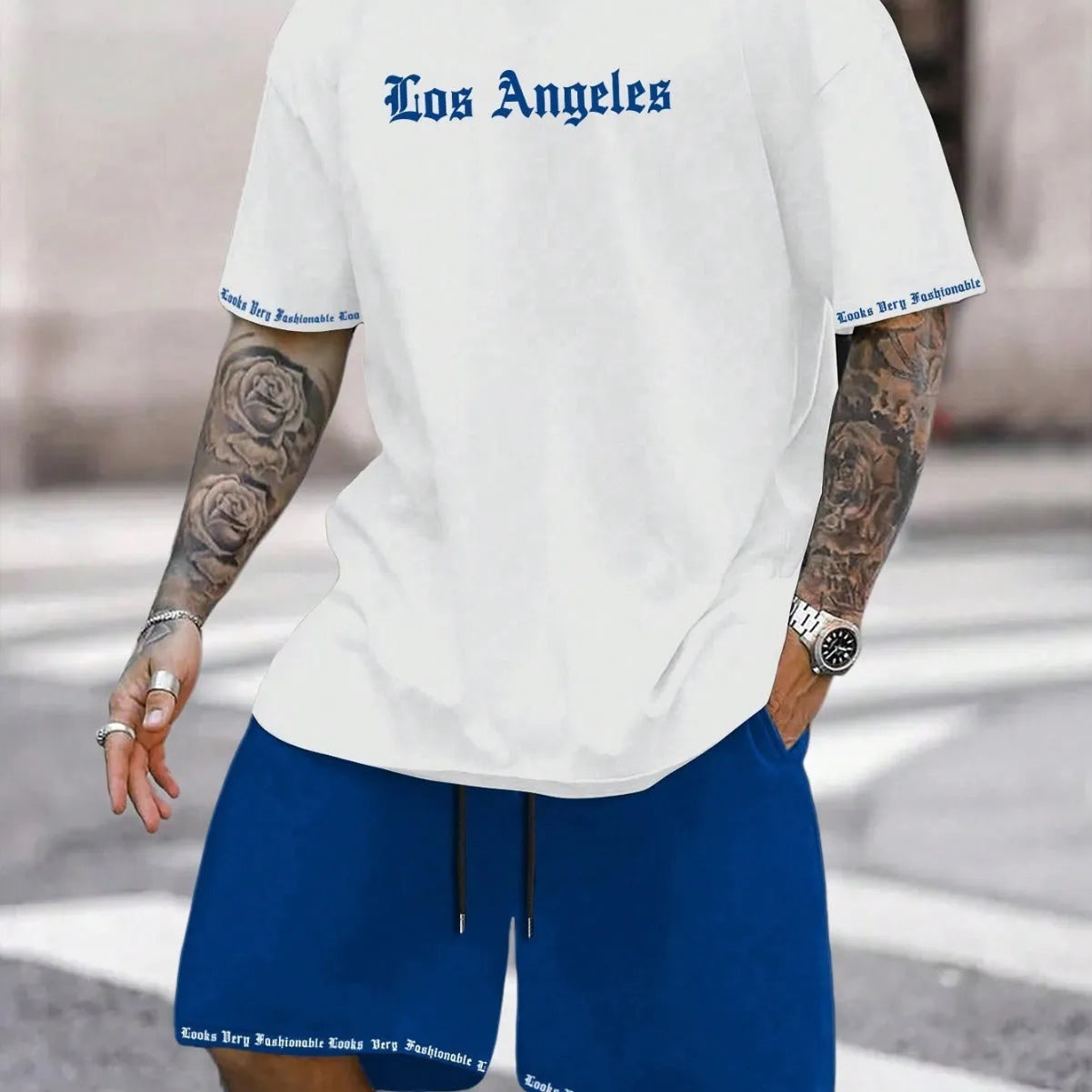 Men's blue printed short-sleeve top and matching shorts sports suit on a hanger.
