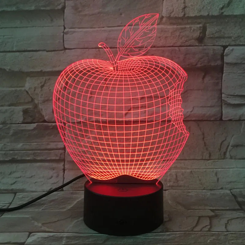 Colourful 3D fruit shaped acrylic LED night light with touch control on a table.