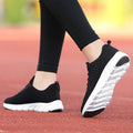 Women's running shoes with fly weaving upper in black, pink, or white colours, showing durable outsole.