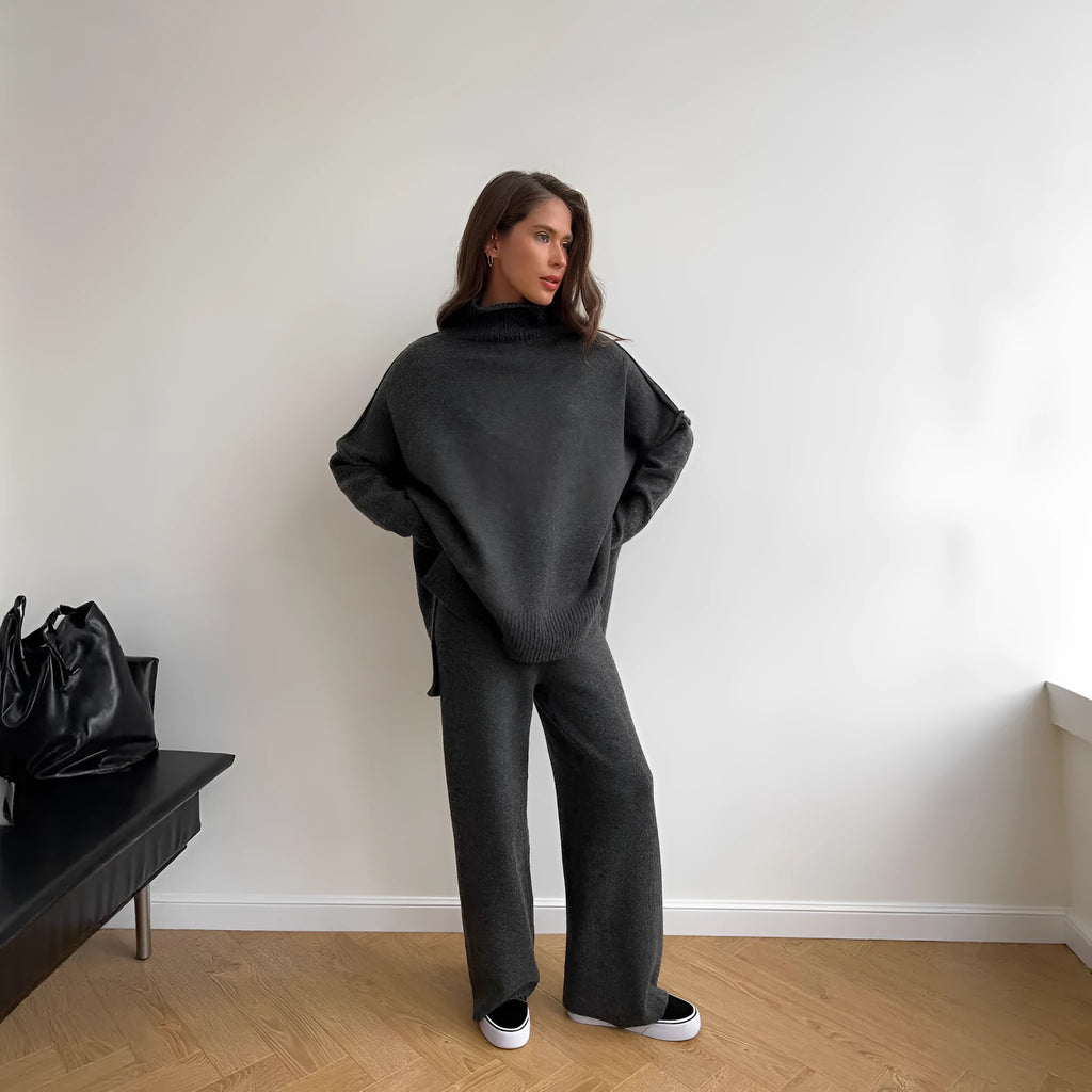Women's acrylic sweater suit with side-slit top and trousers in dark grey.
