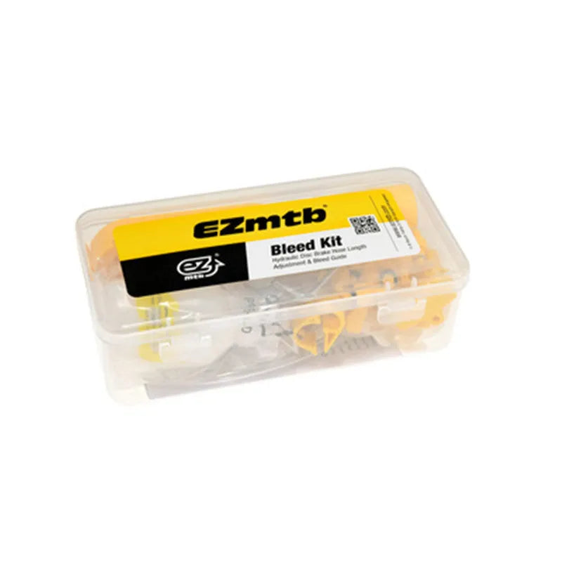 Yellow bicycle disc brake oil change bleed tool kit with metal connector on a workbench