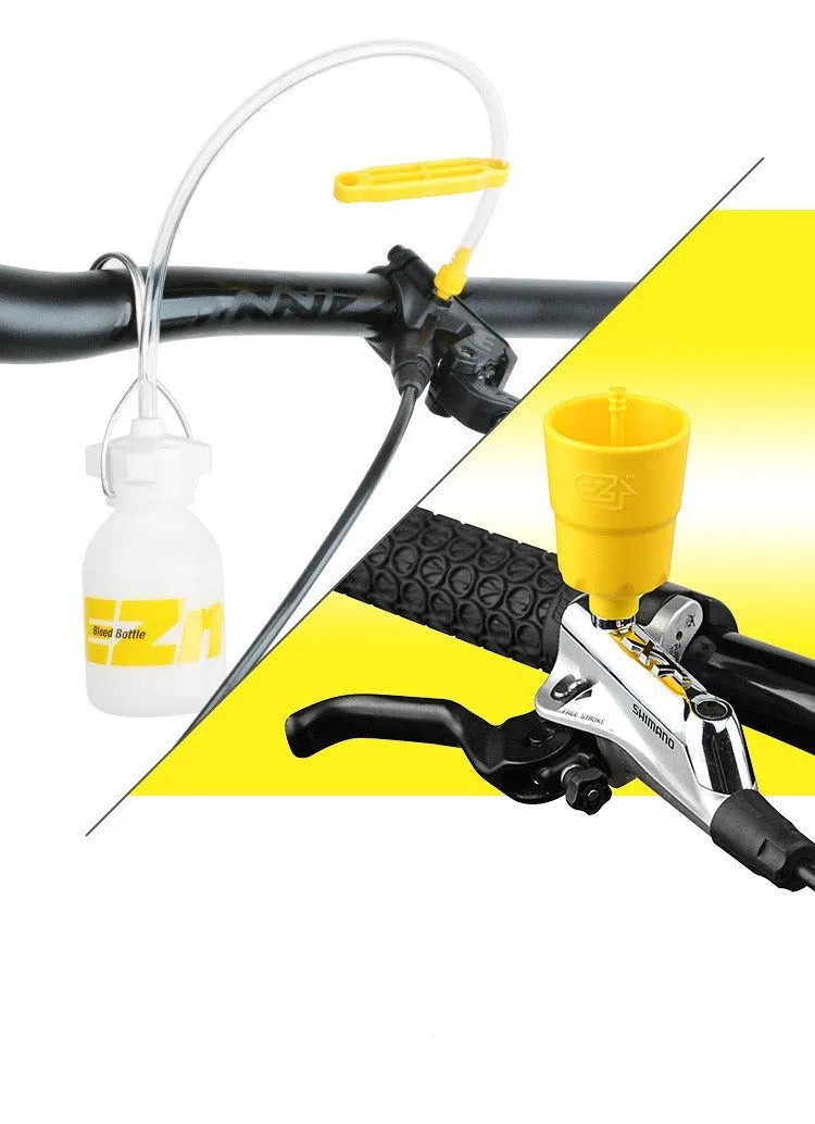 Yellow bicycle disc brake oil change bleed tool kit with metal connector on a workbench