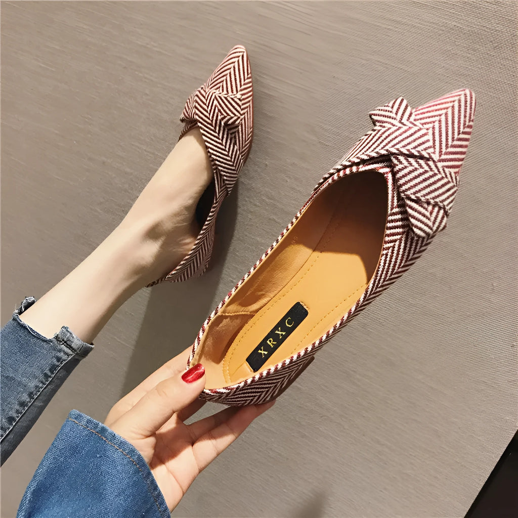 Women's black pointed toe low heel flat shoes with shallow mouth design and cotton upper.