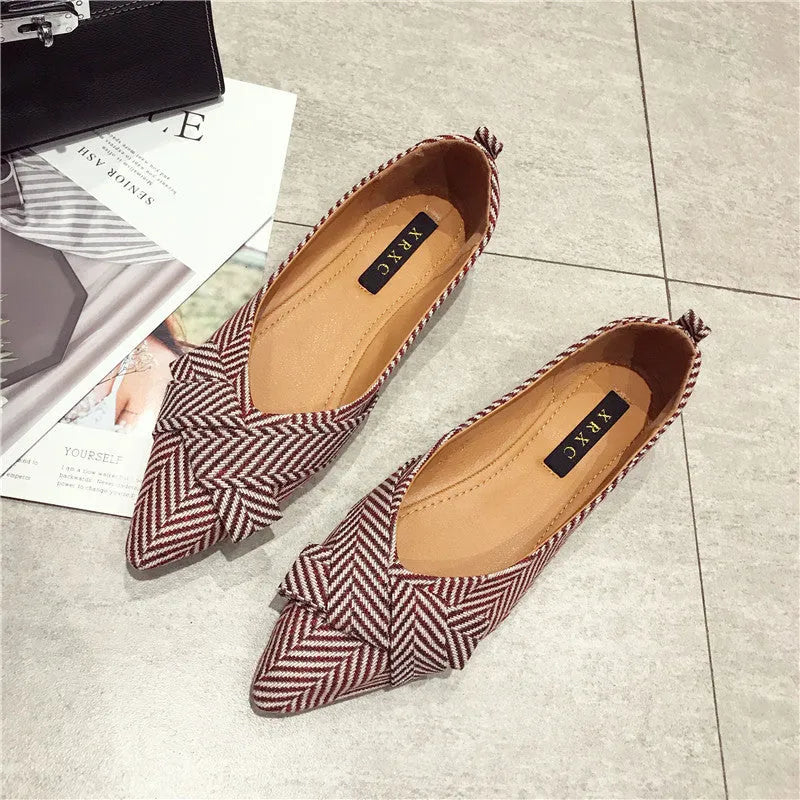 Women's black pointed toe low heel flat shoes with shallow mouth design and cotton upper.