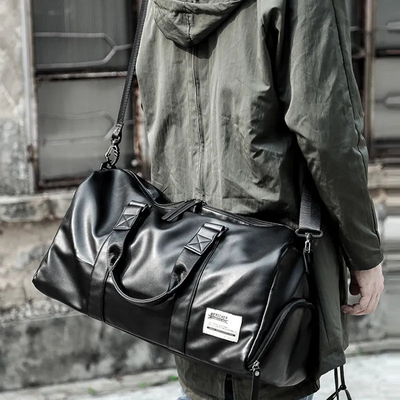 Black waterproof PU leather sports training bag with multiple internal organisation pockets and a single shoulder strap