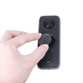 Black tempered glass screen protector for Insta360 ONE X2 camera, shown with cleaning cloth.