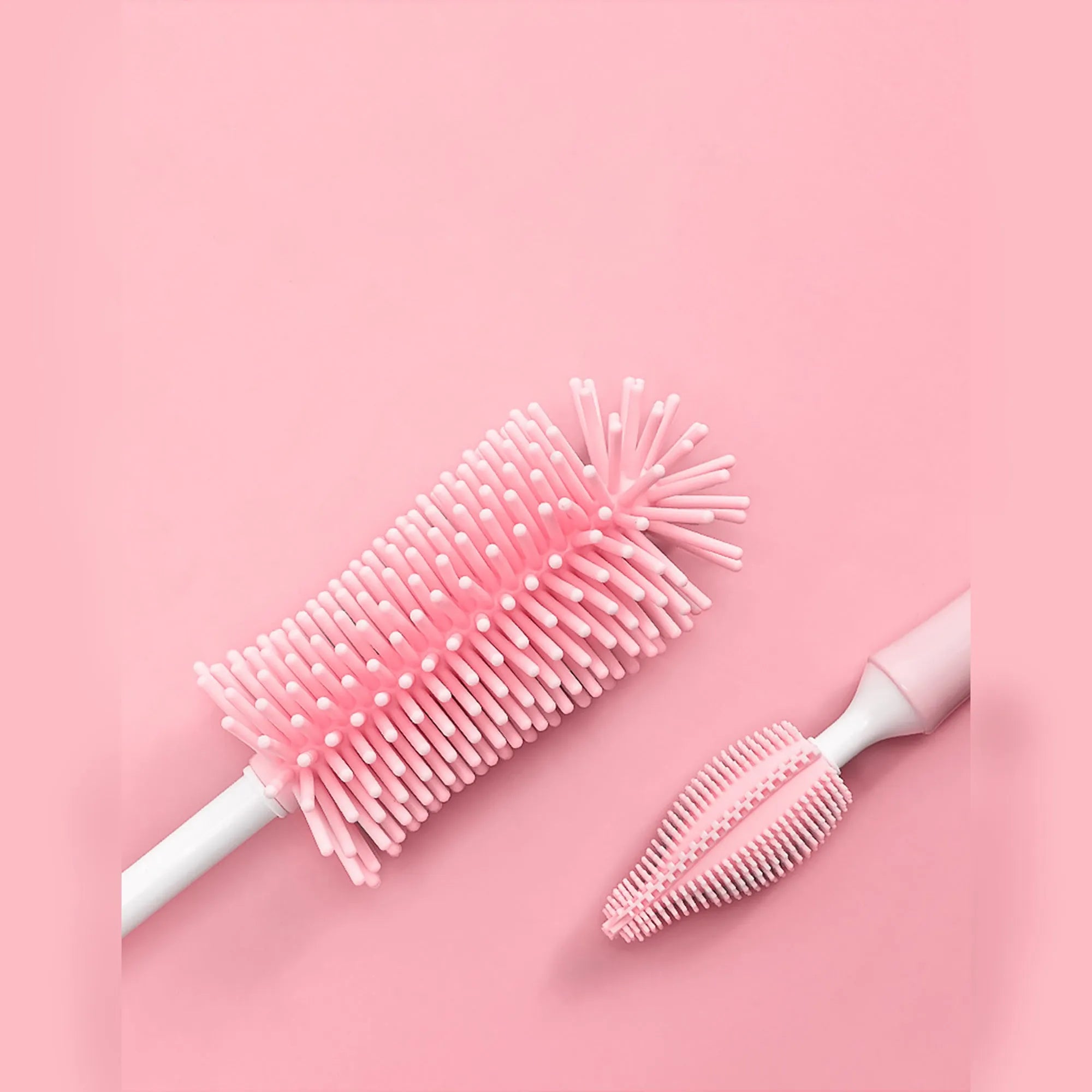 Baby bottle brush set with silicone bristles and a small straw cleaning brush in pink, blue, and yellow colours.