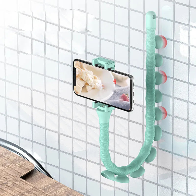 Black flexible phone holder with suction cup mounted to wall showing 62cm adjustable arm holding mobile phone
