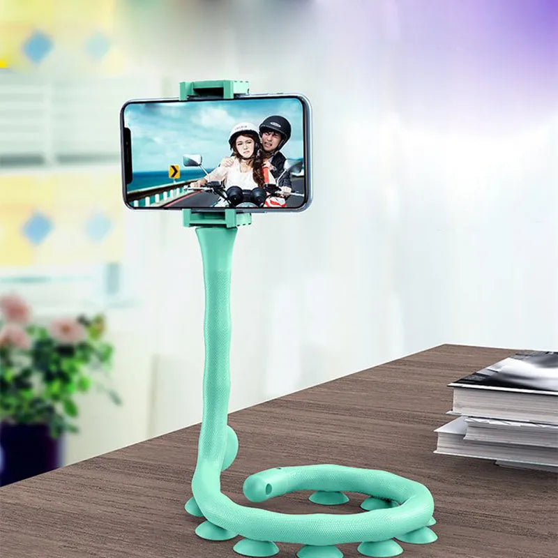 Black flexible phone holder with suction cup mounted to wall showing 62cm adjustable arm holding mobile phone