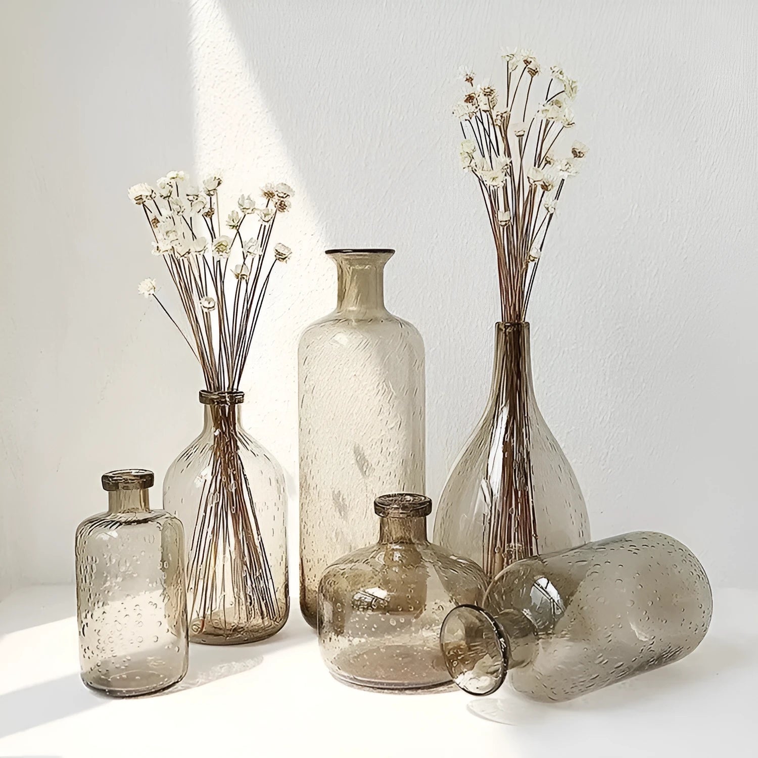 Grey geometric bubble-shaped stained glass vase on a wooden surface.