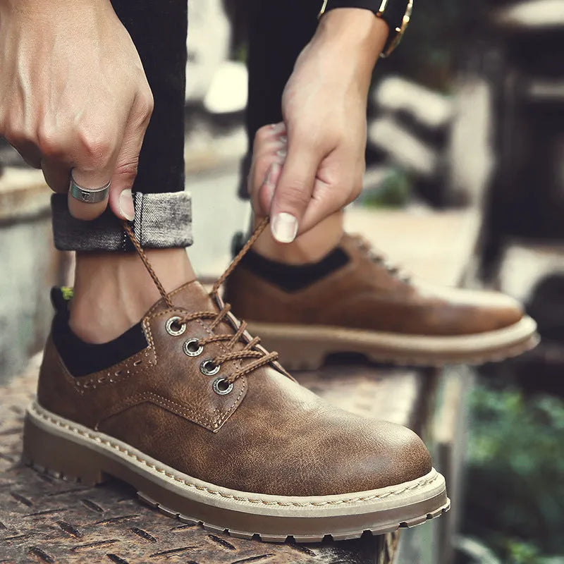 Men's black casual shoes with round toe and front-tie laces on a rubber sole