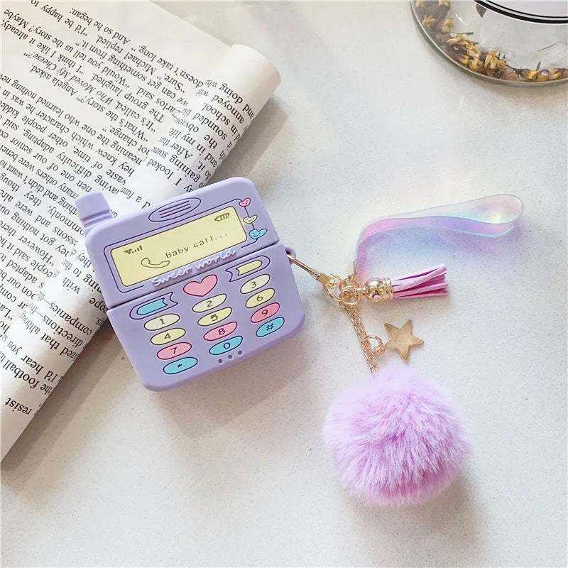 Purple silicone clamshell case for Apple AirPods with fur ball pendant attached