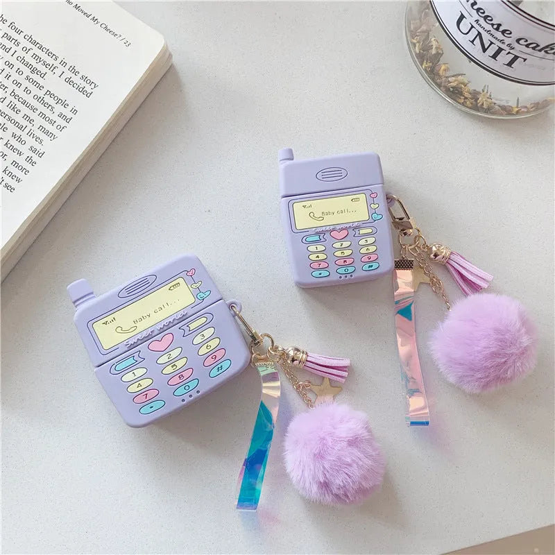 Purple silicone clamshell case for Apple AirPods with fur ball pendant attached