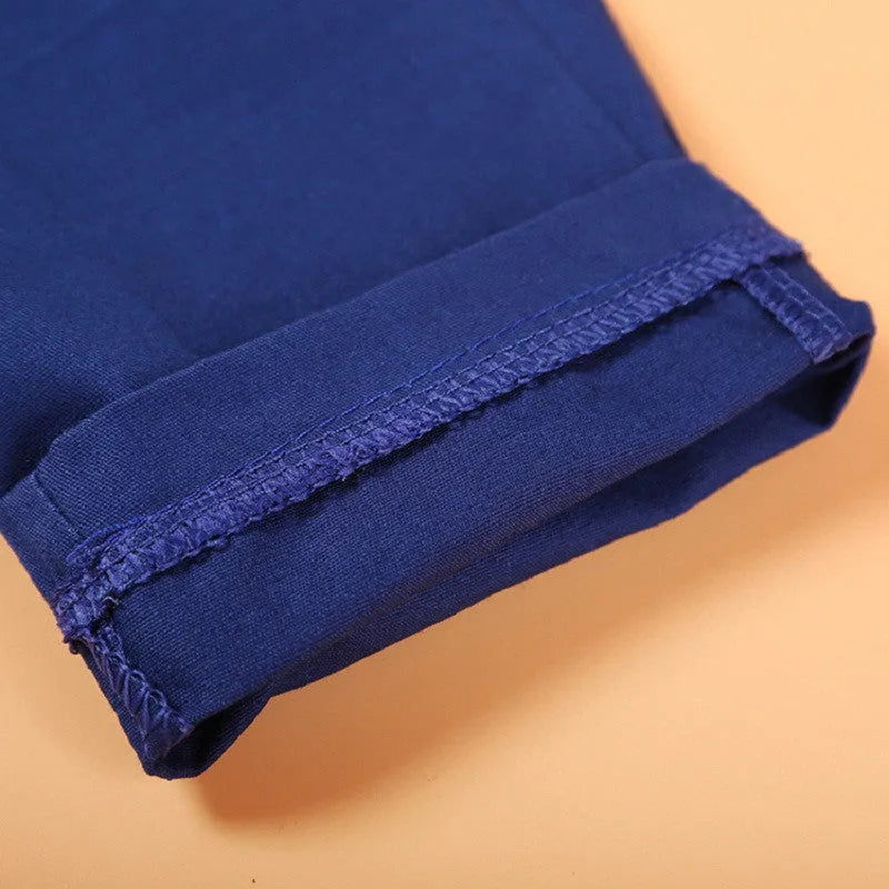 Blue boys' smart casual clothing set with turtleneck, waistcoat, tie, and trousers on a hanger