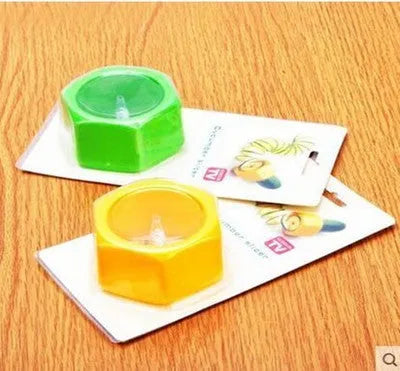 Yellow and green food-grade ABS plastic vegetable cutter with 8cm diameter on a kitchen worktop.