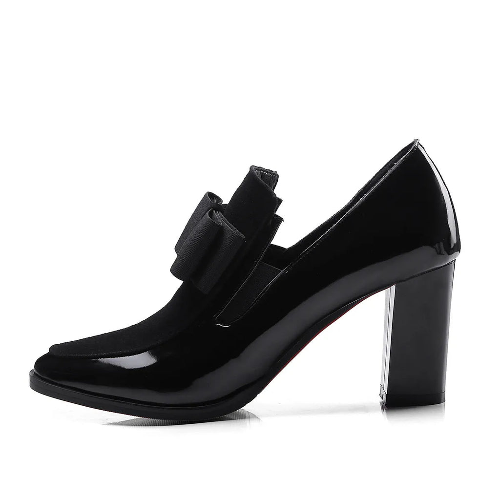 Black patent leather women's high heel shoes with a thick block heel and square toe.