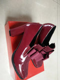 Black patent leather women's high heel shoes with a thick block heel and square toe.