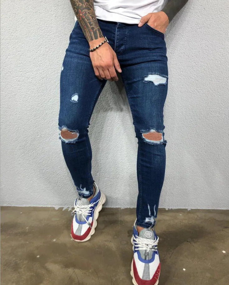 Men's skinny stretch denim jeans in black with ripped knee holes and tapered leg